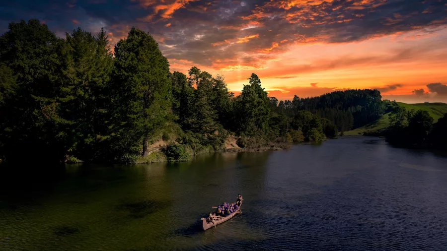 Big Kanu paddling into sunset on Lake McLaren before glowworm canyon tour