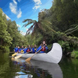 Group enjoying a guided Big Kanu paddle tour on Lake McLaren near Tauranga
