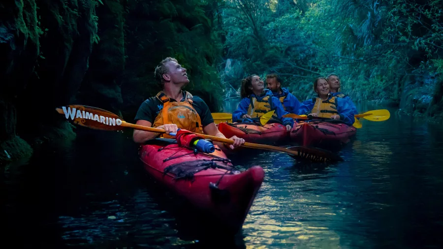 Kayak guide leading a group through the glowworm canyon at Lake McLaren