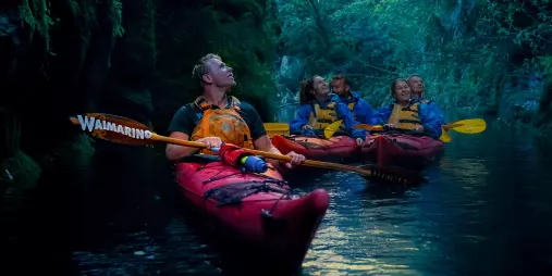Kayak guide leading a group through the glowworm canyon at Lake McLaren