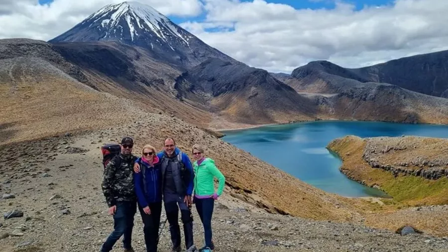 Group of hikers by Tama Lakes with Mount Ngauruhoe in the background