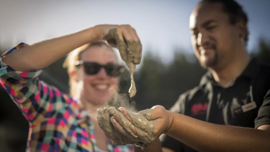 Visitor holding healing geothermal mud from Medicine Lake at Hell’s Gate Rotorua.