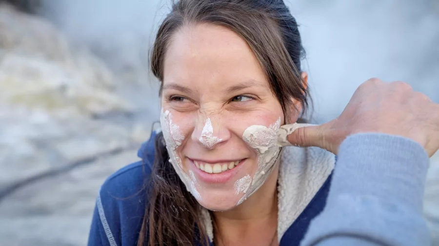Close-up of a woman receiving a white geothermal mud facial at Hell’s Gate Rotorua.