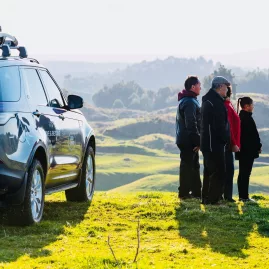 Kahukiwi Experience guests on a scenic hilltop stop with 4WD vehicle in Rotorua.