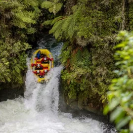 Raft plunging over Tutea Falls in the Ōkere section of the Kaituna River with Kaitiaki Adventures in Rotorua.
