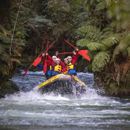 Whitewater rafting through the native forest in the Ōkere section of the Kaituna River near Rotorua.