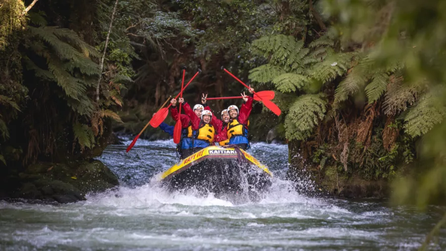 Whitewater rafting through the native forest in the Ōkere section of the Kaituna River near Rotorua.
