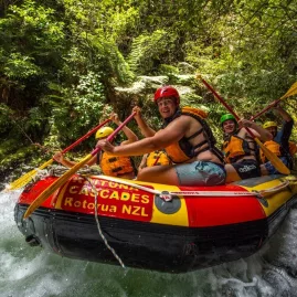 Close-up of excited rafters powering through white water on Kaituna River with Kaituna Cascades.