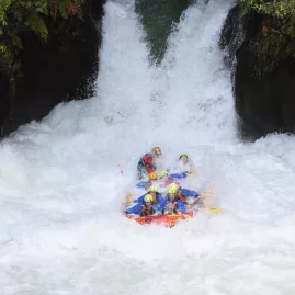 Rafting group plunging down Tutea Falls on the Grade 5 Kaituna River in Rotorua.