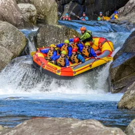 Raft mid-air on a steep Grade 5 waterfall on the Wairoa River near Rotorua.