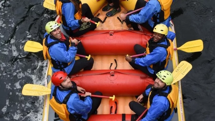 Overhead shot of a rafting crew floating in calm waters between rapids on Wairoa River.