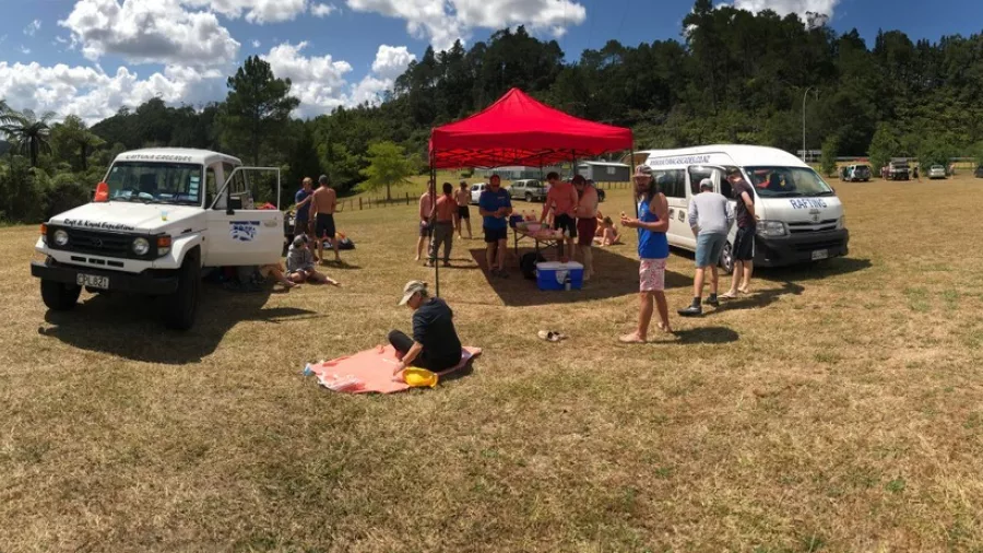 Rafters preparing at Kaituna Cascades basecamp before a Grade 5 rafting trip on Wairoa River.