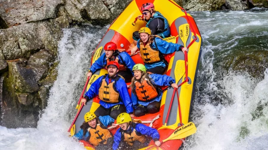 Raft plunging over a steep Grade 5 drop on the Wairoa River with Kaituna Cascades.