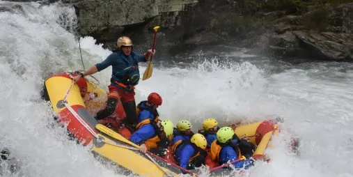 Rafting crew dropping into a powerful rapid on the Wairoa River