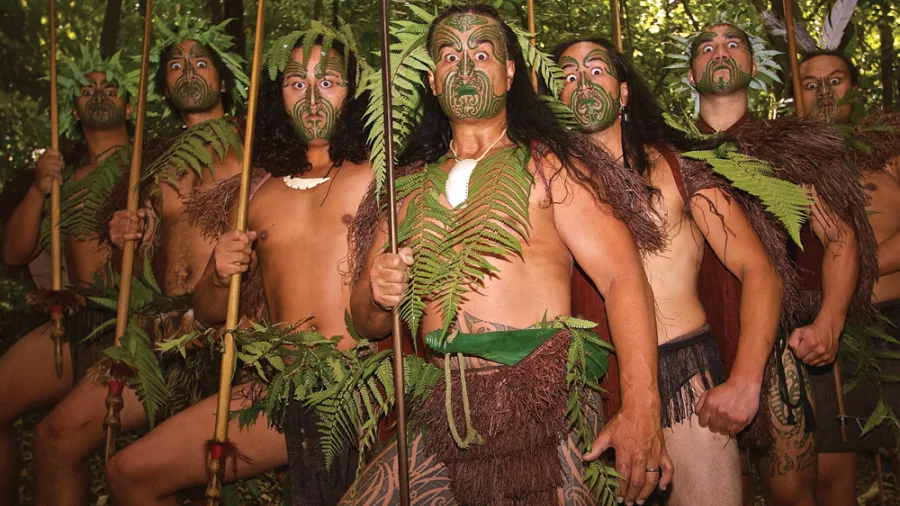 Group of Māori warriors performing the haka at Mitai Māori Village in Rotorua.