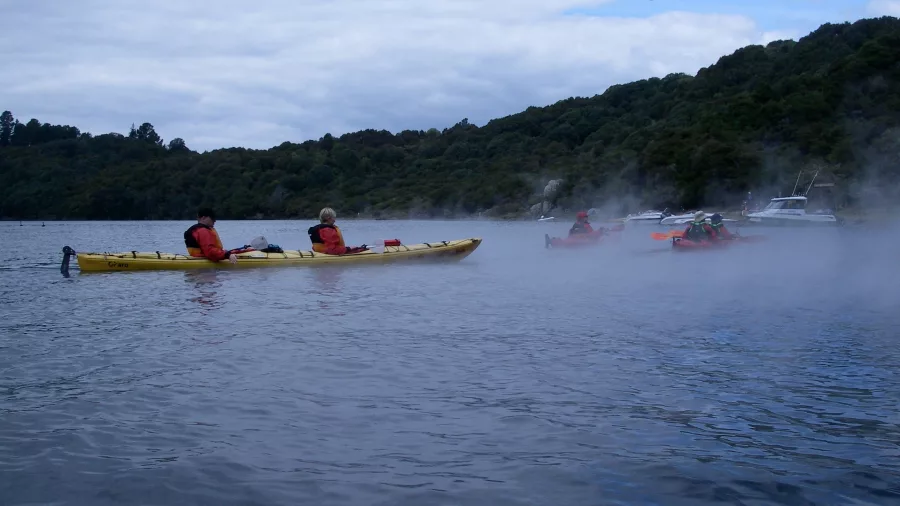 Kayak tour on Lake Tarawera passing steaming geothermal shoreline with River Rats.