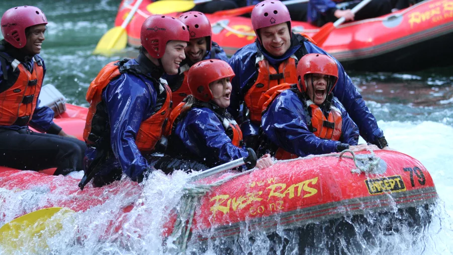 Group of rafters in red helmets enjoying the rapids on the Kaituna River with River Rats.
