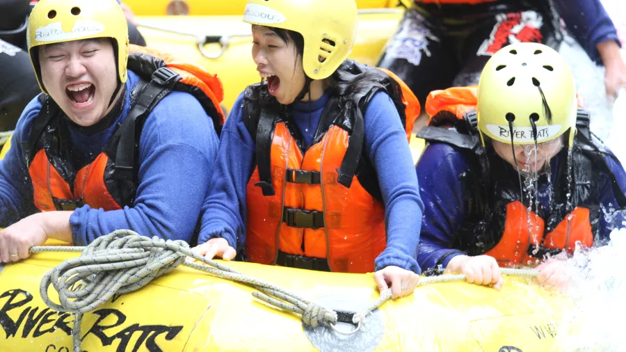 Guests laughing and soaked during an exciting rafting trip with River Rats on the Kaituna River.