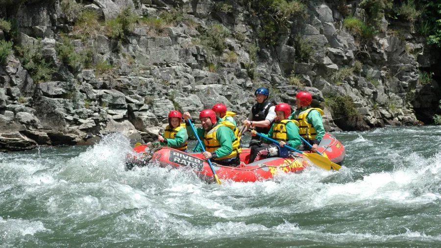 Raft powering through grade 2 rapids on the Lower Rangitāiki River with River Rats.