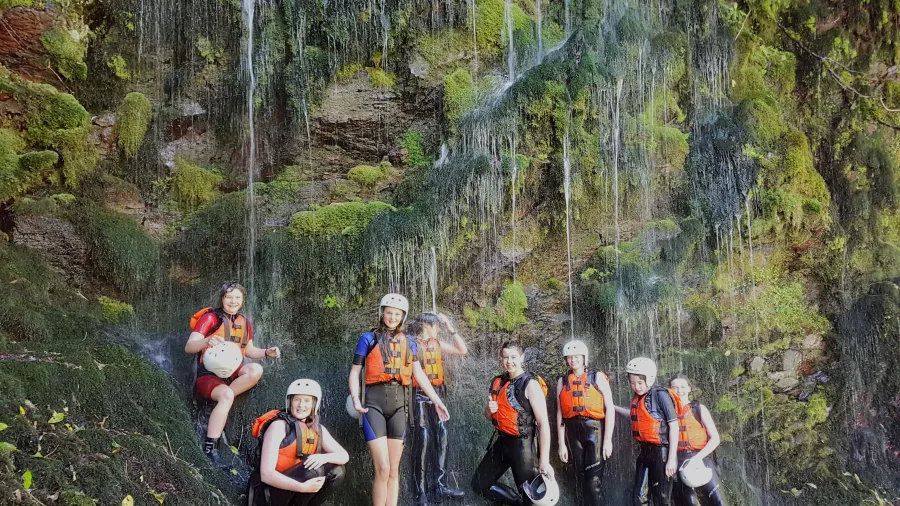 Rafters taking a break by mossy waterfalls on the Lower Rangitāiki River with River Rats.