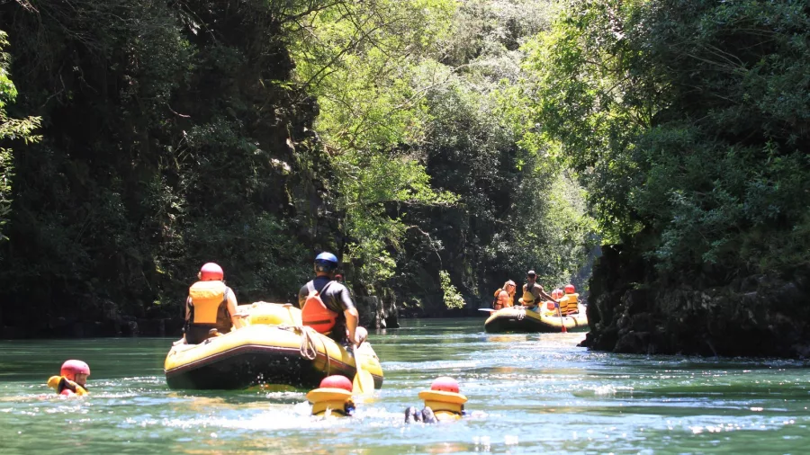 Families floating beside rafts on a scenic stretch of the Lower Rangitāiki River with River Rats.