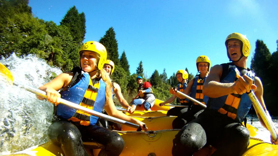 GoPro view of a rafting group paddling hard on the Kaituna River under blue skies