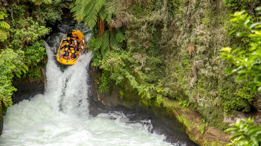 Raft dropping down Tutea Falls, the world’s highest commercially rafted waterfall