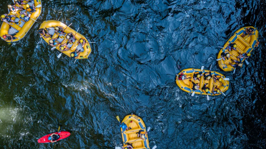 Aerial view of multiple rafts and kayakers on the Kaituna River