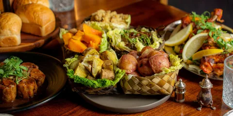 Traditional Māori vegetables like kūmara and taro served in woven flax basket at Te Pā Tū