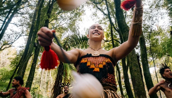Māori woman performing with poi in the forest during a Te Pā Tū cultural experience