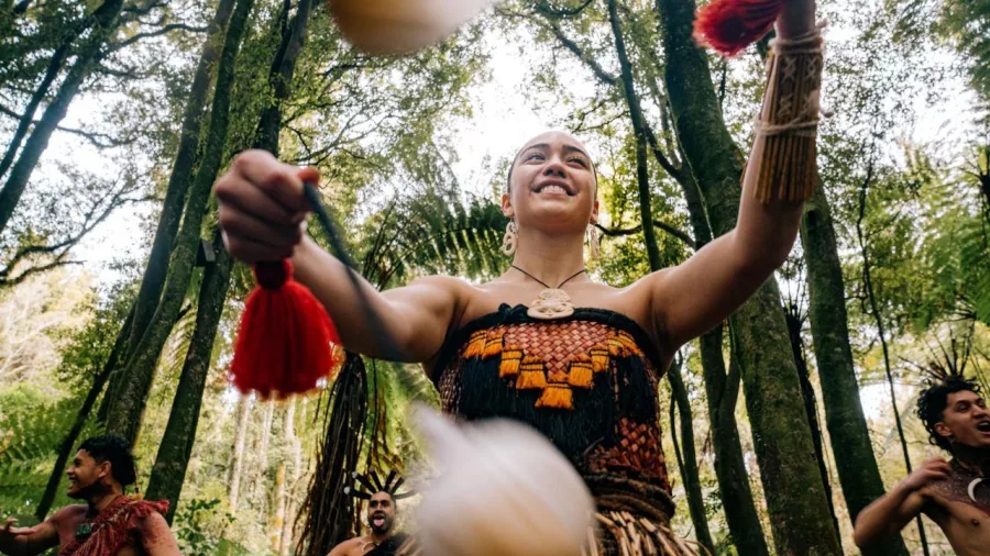 Māori woman performing with poi in the forest during a Te Pā Tū cultural experience