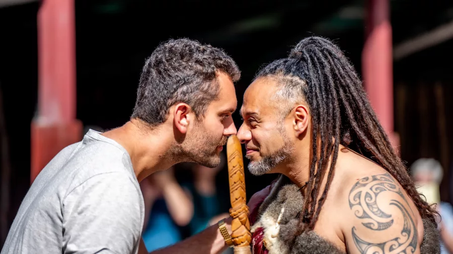A guest and Māori host sharing a hongi greeting during a Te Pā Tū cultural welcome