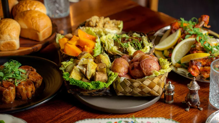 Traditional Māori vegetables like kūmara and taro served in woven flax basket at Te Pā Tū