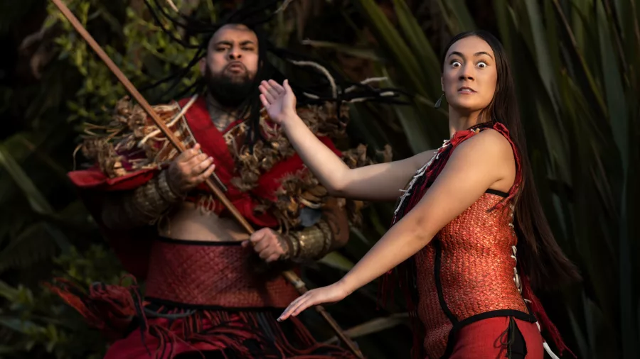 Māori performers in traditional red costumes presenting kapa haka at Te Pā Tū