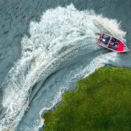 Aerial shot of Agrojet sprint boat making a sharp turn at Velocity Valley