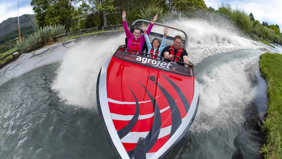 Three people enjoying a high-speed Agrojet ride at Velocity Valley in Rotorua