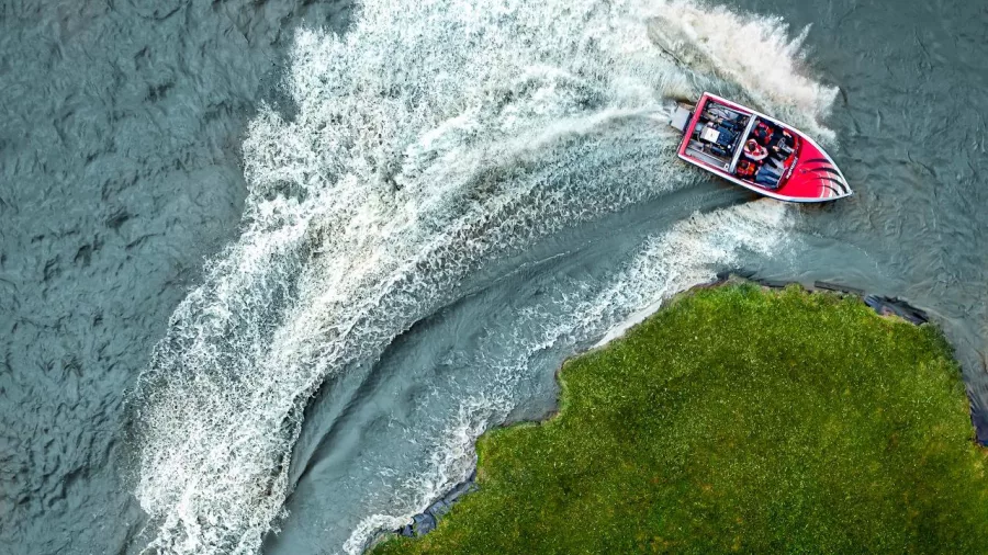Aerial shot of Agrojet sprint boat making a sharp turn at Velocity Valley