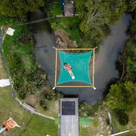 Overhead shot of a person falling into the Vertigo safety net from high above in Rotorua