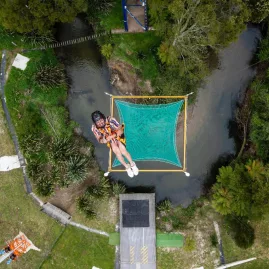 Person mid-air just before landing in the safety net on the Vertigo freefall ride in Rotorua