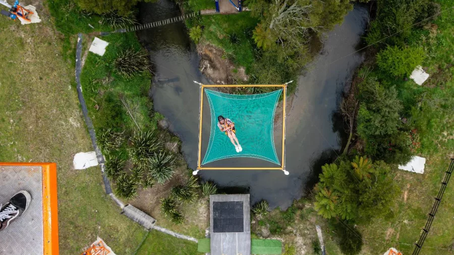 Overhead shot of a person falling into the Vertigo safety net from high above in Rotorua