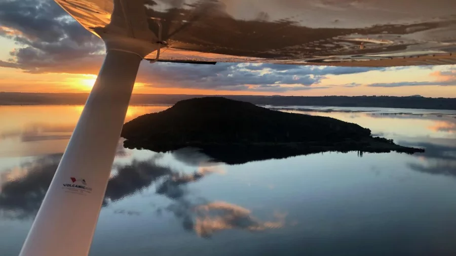 View of Mokoia Island at sunset from a floatplane wing over Lake Rotorua