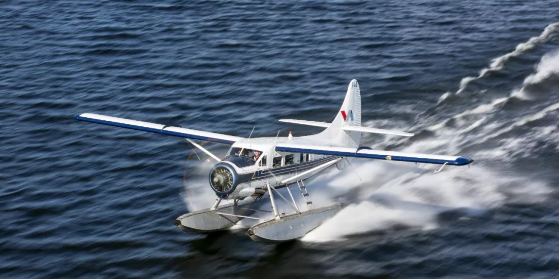 Volcanic Air floatplane skimming across Lake Rotorua as it takes off