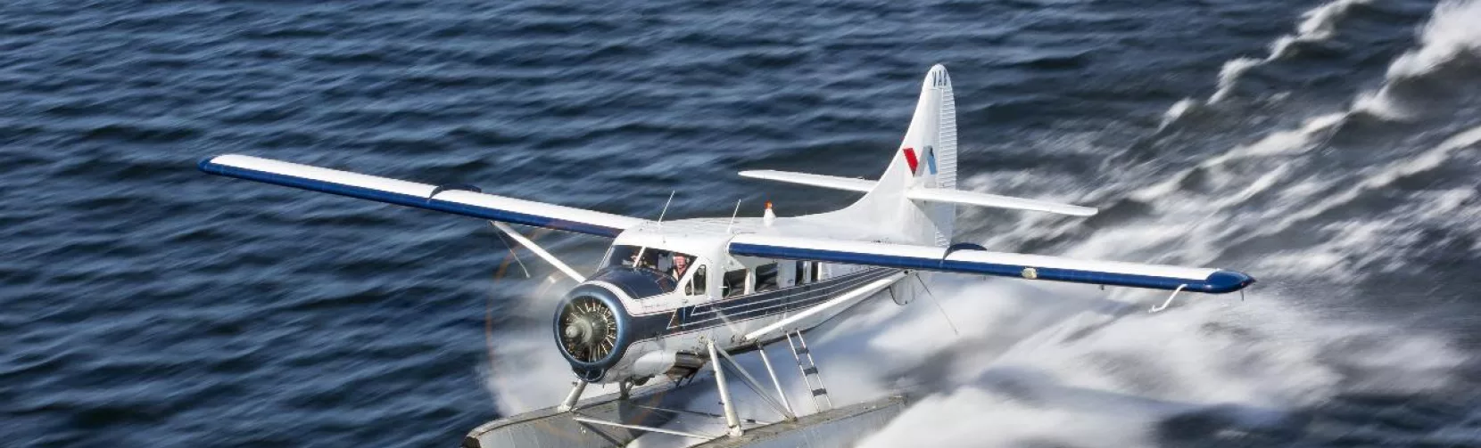 Volcanic Air floatplane skimming across Lake Rotorua as it takes off