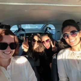 Happy passengers smiling inside a Volcanic Air floatplane cabin mid-flight