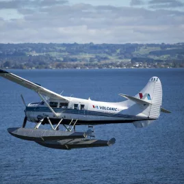 Volcanic Air floatplane flying low over Lake Rotorua on a scenic flight