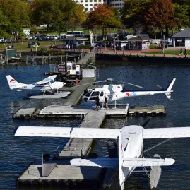 Volcanic Air floatplanes and helicopter docked at the Lake Rotorua waterfront jetty