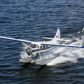 Volcanic Air floatplane skimming across Lake Rotorua as it takes off