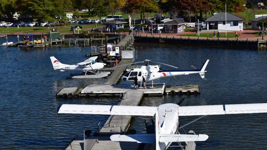 Volcanic Air floatplanes and helicopter docked at the Lake Rotorua waterfront jetty
