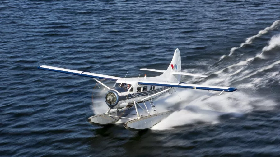 Volcanic Air floatplane skimming across Lake Rotorua as it takes off