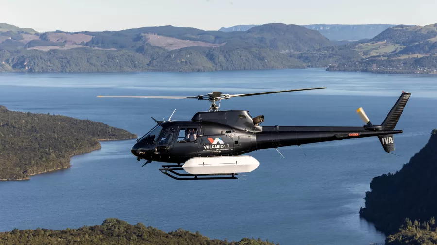 Volcanic Air Squirrel helicopter flying above Lake Tarawera, New Zealand